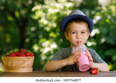 Little Boy Drinking Strawberry Milkshake From Disposable Plastic Glass Outdoors. Portrait Of Happy Smiling Kid With Smoothie