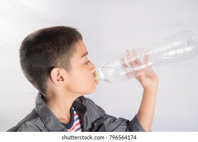 Little Boy Drinking Water From The Bottle