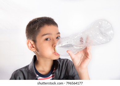 Little Boy Drinking Water From The Bottle