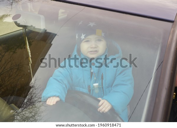 a little boy drive a\
real car. a little boy sitting forward in a real car.a little boy\
drive alone a car. 