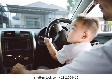 Little boy driving car with father for going travel, happy family leisure in holiday weekend, Soft focus.