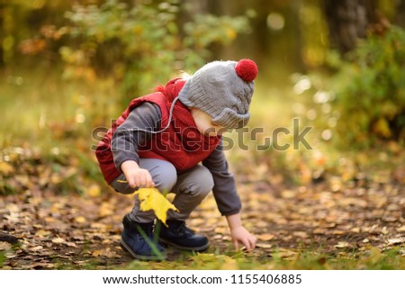 Similar – Image, Stock Photo Sun always shines after the rain. Small bond infant boy wearing yellow rubber boots and yellow waterproof raincoat walking in puddles in city park on sunny rainy day.