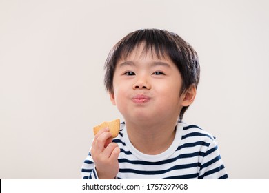 Little boy eat cookie on white background - Powered by Shutterstock