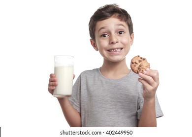 Little Boy Eating Chocolate Chip Cookie And Milk