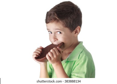 Little Boy Eating Chocolate Easter Egg On White Background