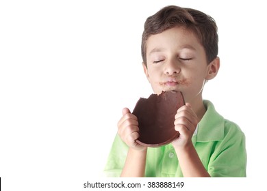 Little Boy Eating Chocolate Easter Egg On White Background