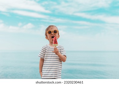 Little boy eating delicious ice cream watermelon, outdoor, summer concept - Powered by Shutterstock