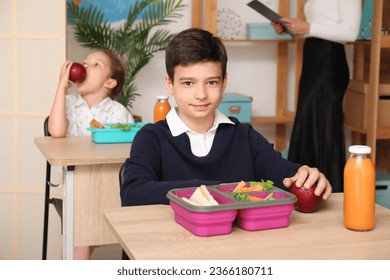 Little boy eating lunch in classroom - Powered by Shutterstock