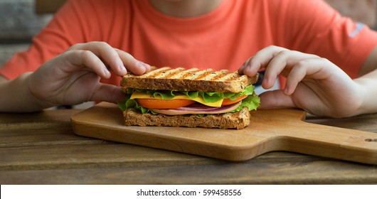 Little Boy Eats A Huge Sandwich.