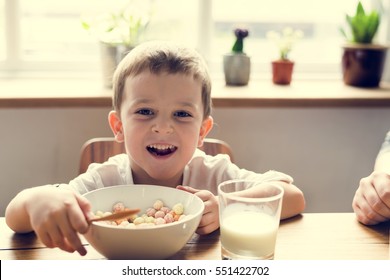 Little Boy Enjoying Bowl Of Cereal