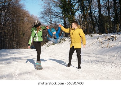 Little Boy Enjoying A Sleigh Ride. Child Sledding With Young Mom And Dad. Toddler Kid Riding A Sledge. Children Play Outdoors In Snow. Kids Sled In Winter Park. Outdoor Active Fun For Family Vacation.