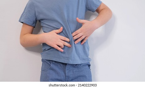 Little Boy Experiences Abdominal Pain. Baby's Medication And Health Concept. Stomach Ache. Suffering A Young Child. Food Poisoning, Abdominal Pain. Health Problems In Children.