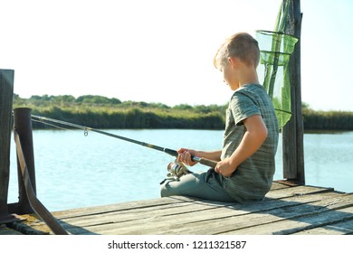 Little Boy Fishing Alone On Sunny Day. Space For Text