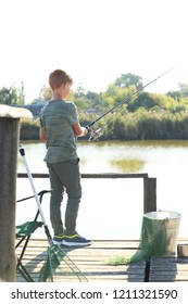 Little Boy Fishing Alone On Sunny Day