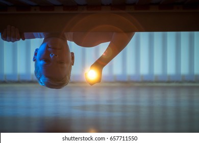 The Little Boy With A Flashlight Under The Bed. Night Time