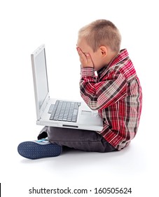 Little boy in front of laptop hiding his face - Shutterstock ID 160505624