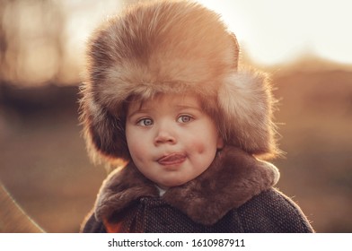 A little boy in the fur hat
