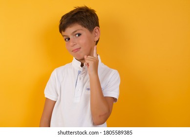 Little Boy Gesturing A No Sign. Closeup Portrait Unhappy, Serious Guy Raising Finger Up Saying: Oh No You Did Not Do That. Standing Over Yellow Background. Negative Emotions And Facial Expressions.