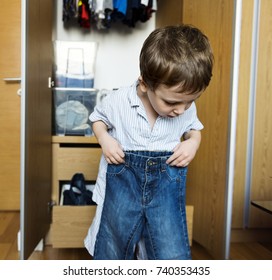 Little Boy Getting Dressed By Himself