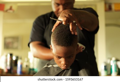 Little Boy Getting Hair Cut By Barber