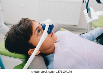 Little boy getting Inhalation Sedation while teeth treatment at dental clinic. Teeth treatment child - Shutterstock ID 1573109176