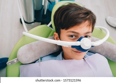 Little boy getting Inhalation Sedation while teeth treatment at dental clinic. Teeth treatment child - Shutterstock ID 1573121596