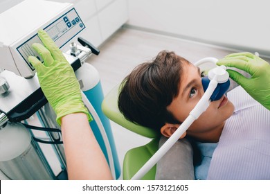 Little boy getting Inhalation Sedation while teeth treatment at dental clinic. Teeth treatment child - Shutterstock ID 1573121605