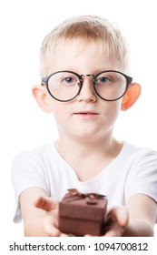 Little Boy With A Gift In Hands, The Child Congratulates Mom And Dad, Photo Isolated On White Background