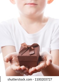 Little Boy With A Gift In Hands, The Child Congratulates Mom And Dad, Photo Isolated On White Background