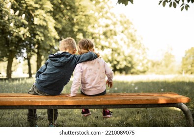 Little boy girl, brother sister bonding sitting on park bench. Family, sibling relationships  - Powered by Shutterstock