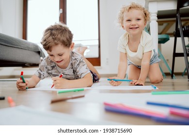 Little Boy And Girl Draw Together In White Room With Window. Kids Doing Homework, Drawing. Children Paint Pencils. Art And Crafts For Toddler And Preschooler