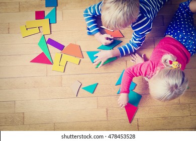 little boy and girl playing with geometric shapes