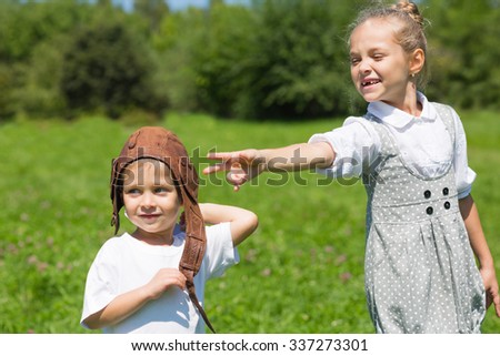 Little boy and girl playing in the park. Brother and sister. Series of images.