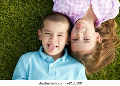 Little Boy And Girl Sitting Outside