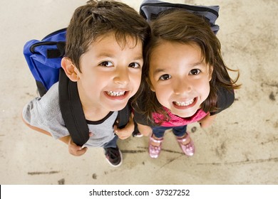 Little boy and girl with their book bags