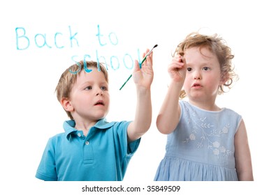 Little Boy And Girl Writing Back To School On Glass