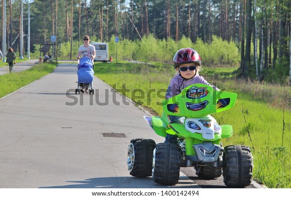 little boy goes for drive on electric quad bike.\
Tver Russia 2012. Sunny summer day. little boy rides his electric\
ATV quad. little boy of 5 years risk riding ATV quad bike in race\
track. quadbike