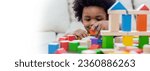 Little boy hands of little children play blocks in classroom. Learning by playing education group study concept. International pupils do activities brain training in primary school background banner