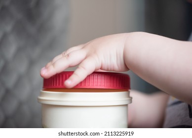 Little Boy Hands Opens A Cover Of A Jar Close Up.