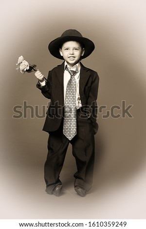 Similar – stylish little gentleman in hat looking up