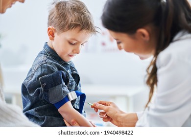 Little Boy Having Blood Sample Drawn In A Lab