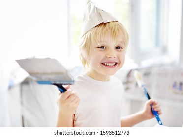 Little Boy Having Fun With Paint Brush During Repair Of Room. Do It Yourself.