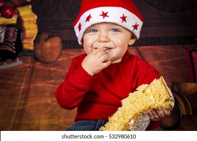 Little Boy Having Fun While He's Eating A Christmas Cake.