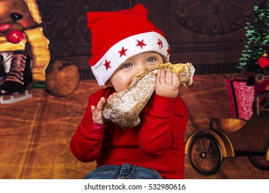 Little Boy Having Fun While He's Eating A Christmas Cake.