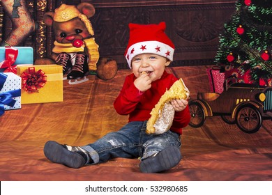 Little Boy Having Fun While He's Eating A Christmas Cake.