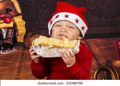 Little Boy Having Fun While He's Eating A Christmas Cake.