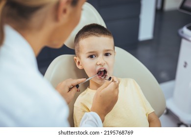 Little Boy Having Regular Dental Check-up. Cute Boy Smiling While Teeth Exam . Happy Boy Sitting In Dentists Chair And Having Check Up Teeth. Portrait Of Smiling Little Boy Sitting In Dental Chair