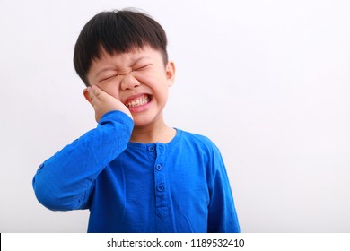 Little Boy Having Toothache. Emotional Portrait Of Asian Boy Suffering. Sad Child With Tooth Pain. Dental Problem - Kid Suffering From Toothache.