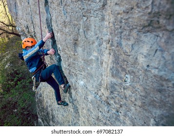 The Little Boy In The Helmet Climbs The Rock, Kid Rock Climber Sports Outdoors.