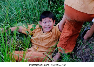 Little Boy Helping Another Boy By Pulling Hand Up